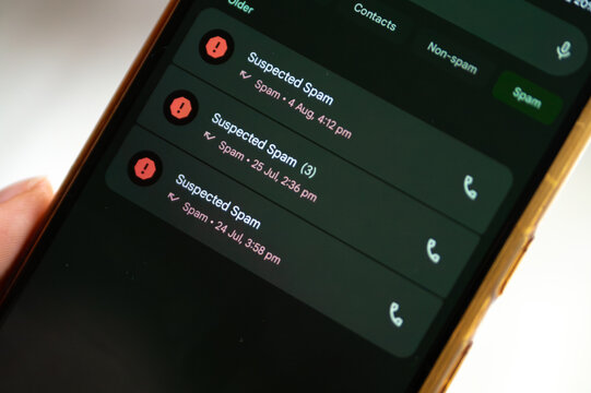 History of Suspected Spam Calls. A mobile phone screen displays a list of past calls, all labeled as "Suspected Spam." The repetition of the warning icon and text shows the persistent nature of spam.