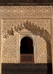Medina of Fez, Morocco. Intricately carved wooden panel and elaborate Arabesque stucco facade of a...