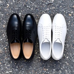 Two shoes, black and white, on asphalt (1)
