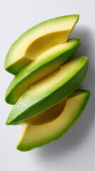 Refreshing flat lay top view of fresh green avocado slice. Healthy food ingredient on white background, evoking clean, natural feeling perfect for wellness and diet concepts