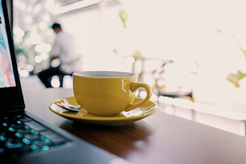 Modern Laptop with Blank Black Screen on Wooden Table Beside Coffee Cup and Smartphone – Workspace, Remote Work, Freelancer Lifestyle, and Home Office Concept