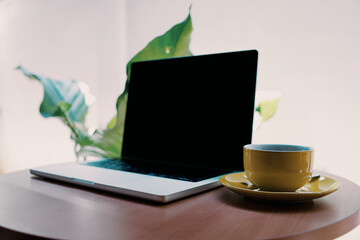Modern Laptop with Blank Black Screen on Wooden Table Beside Coffee Cup and Smartphone – Workspace, Remote Work, Freelancer Lifestyle, and Home Office Concept