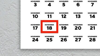 Close-up of the date November 18th marked with a red cursor on the wall calendar 2025