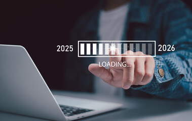 Human touch on loading to change from 2025 to 2026, merry christmas and happy new year, countdown, trend on 2026, technology, new business start up and new life, business plan and development