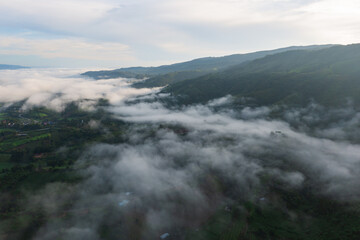 Aerial view of rice terraces and village in Loei province, Thailand.