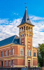 Naklejka premium Old post office in Spremberg Oberlausitz with architecture of red brick, tower and street view in the afternoon