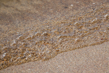 Small Sea Waves Touching Sandy Beach Shore in Natural Coastal Scene