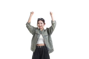 Joyful Upward Gesture: A vibrant woman celebrates in a burst of elation, her arms triumphantly raised in a moment of pure joy. This photo captures the spirit of success, resilience.