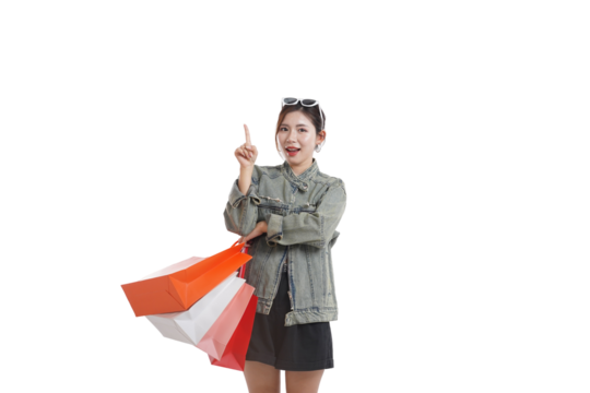 Shopping Discovery: An attractive individual with sunglasses holds shopping bags, pointing upwards to the sky, symbolizing the spirit of discovery and excitement of purchase.