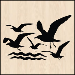 Obraz premium Black vector silhouette of seagulls flying over ocean waves