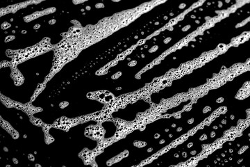Grunge scratched surface backdrop. Soft flowing abstract pattern in black and white, useful for decoration, wallpaper, and creative layouts.