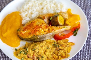 Traditional Brazilian fish moqueca with fresh yellow hake fish fillets, Cynoscion acoupa, with...