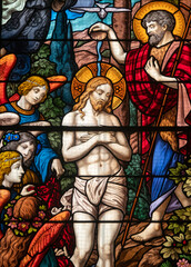 Stained glass (1934) of Baptism of Jesus by John the Baptist in the Jordan river.