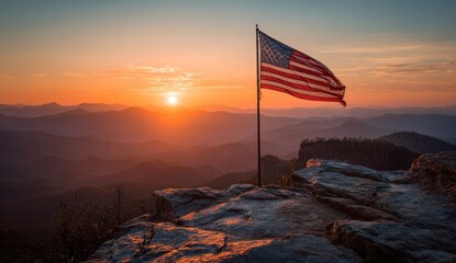 American flag at sunrise over mountains