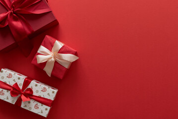 Border from Christmas gifts on a red background.