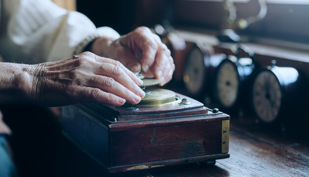 Elder hands teaching child to wind mechanical music box fingers guiding crank batteries or screens on wooden shelf