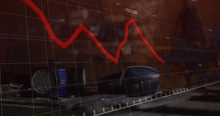 Red chart trending across office desk, with mouse, earcup, tumbler, grid overlay, 52