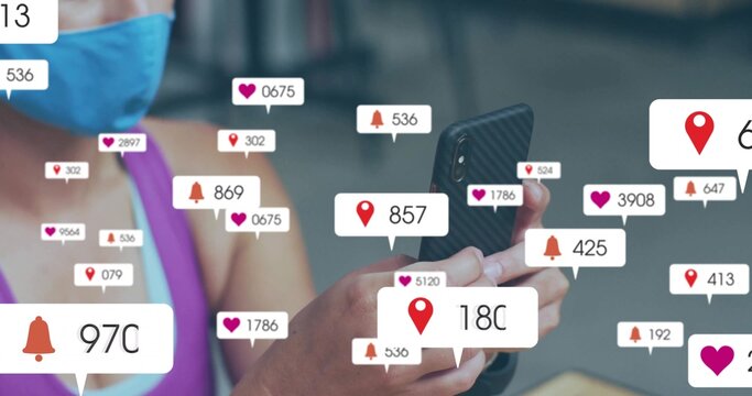 Blue mask purple top woman scrolling smartphone at table, with social media notification icons - Powered by Adobe