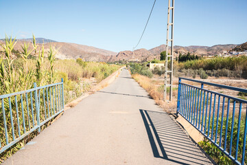 a paved road along the Nacimiento river next to Alhabia, province of Almeria, Andalusia, Spain