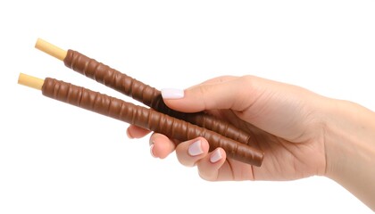 Naklejka premium Hand holding chocolate-covered sticks