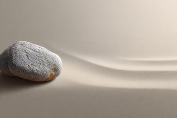 photorealistic representation of ultraminimalism featuring single stone on sandy background