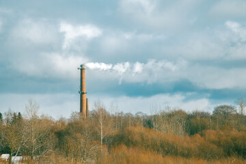 Smoke Stack with Blue Sky and Green Trees