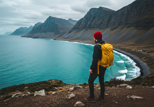Hiker with Yellow Backpack Overlooking Rugged Coastline — Adventure Travel Landscape - Powered by Adobe