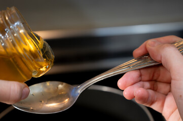 Honey or Maple Syrup Pouring on Spoon