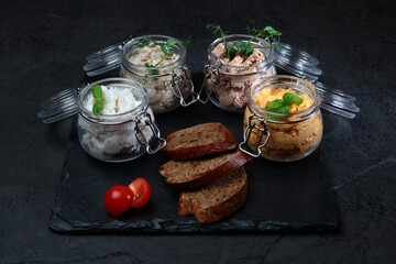 Pates in assortment are arranged in jars. Liver paste. Slices of rye bread. Healthy breakfast.