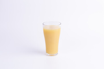 A glass of fresh starfruit juice with frothy texture on white background, perfect for themes of tropical drink, healthy lifestyle, summer refreshment, and copy space.
