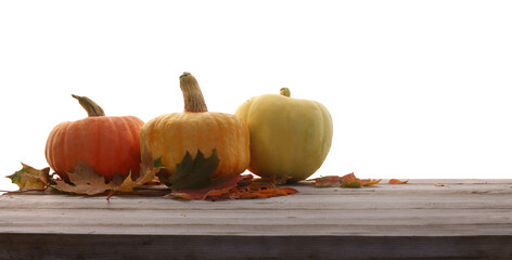  Ripe pumpkins, and autumn leaves on a wooden table cutouts
