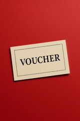 Obraz premium Voucher card displayed on a vibrant red background for promotional marketing purposes