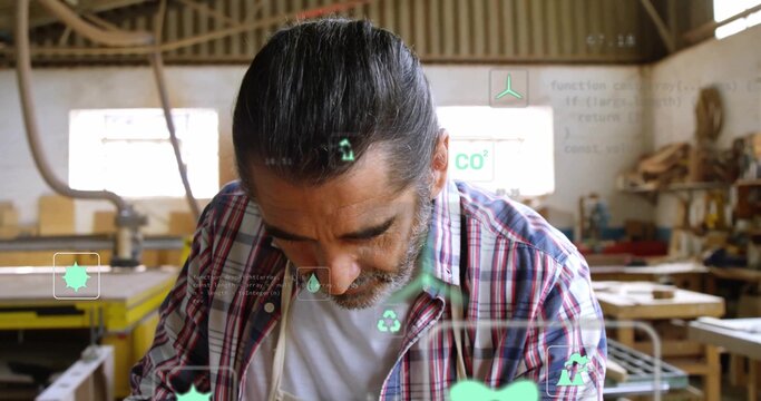 Leaning veteran craftsman scanning digital icons in woodworking workshop, with wooden planks - Powered by Adobe
