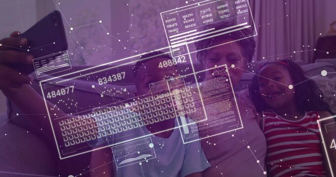 Leaning senior woman with grandchildren taking smartphone selfie on couch at home with data overlay