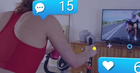 Pedaling woman in red top holding water bottle on bike at home, monitor notifications, copy space