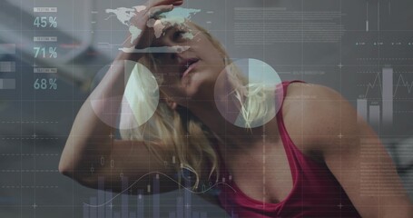 Leaning athlete in red tank top wiping sweat from forehead in fitness center, with digital overlays
