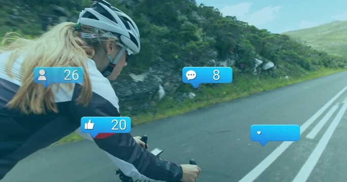 Pedaling woman cyclist in white jersey on mountain road, with social media icons, copy space - Powered by Adobe