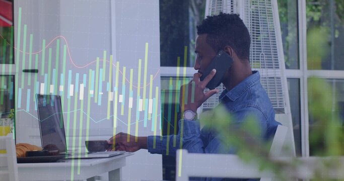 Holding smartphone and typing on laptop at outdoor cafe terrace with heater, croissants, copy space