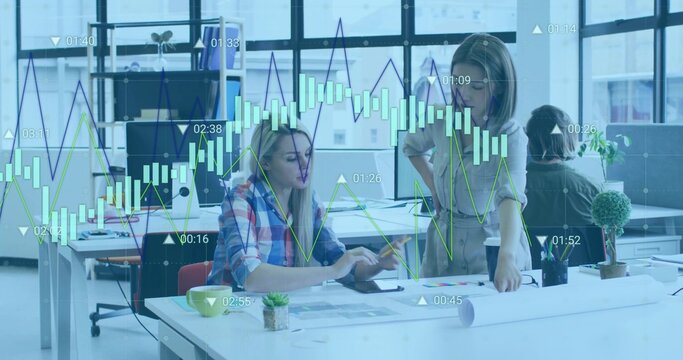 Collaborating coworkers discussing architectural blueprints at desk in modern office, with tablet