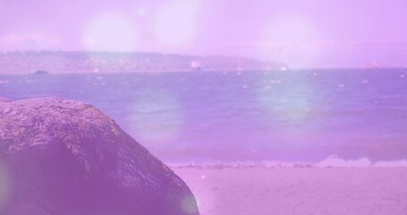 Naklejka premium Sitting large textured rock on sandy shoreline, with pastel haze over calm sea, copy space