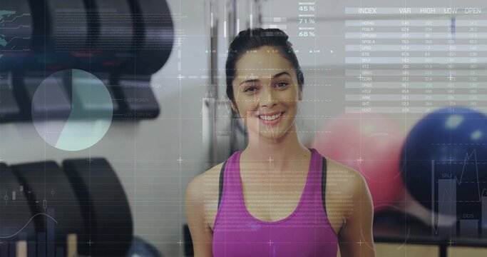 Tracking athletic woman wearing bright pink sports top lifting dumbbell in gym, with data overlay - Powered by Adobe