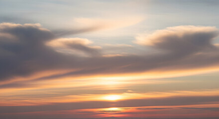 Breathtaking sunset paints sky with vibrant orange, pink, and gold hues, creating a serene and majestic natural spectacle
