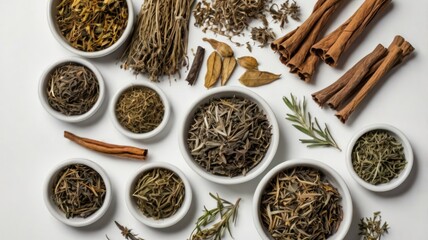 Fototapeta premium Various dried herbs and spices in small white bowls arranged on a white surface, showcasing a collection of natural culinary and medicinal ingredients.