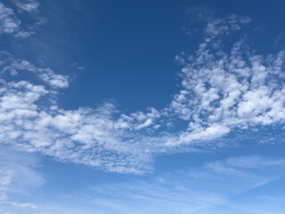 Soft bright blue sky with white few clouds. Calm texture. Nature abstract background. Fresh air, weather and freedom concept. Clear sky in the morning. The cloud float and clump like cotton.
