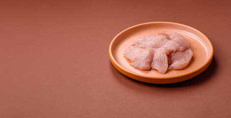 Slices of raw chicken or turkey breast, skinless and boneless. Chicken breast slices