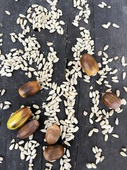 Unique Variety of Nuts and Seeds Scattered on a Wooden Surface