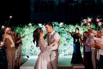 newlyweds at a wedding of sparklers
