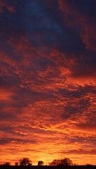 Fototapeta premium Fiery sunset sky landscape Dramatic cloudscape at dusk Colorful sky background Orange and red colors Natural phenomenon image