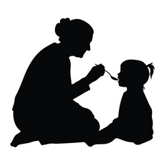 Woman feeding child with spoon silhouette