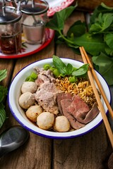 Noodle soup with sliced pork, pig blood, meatball and Thai morning glory,Nam Tok noodles with instant noodles